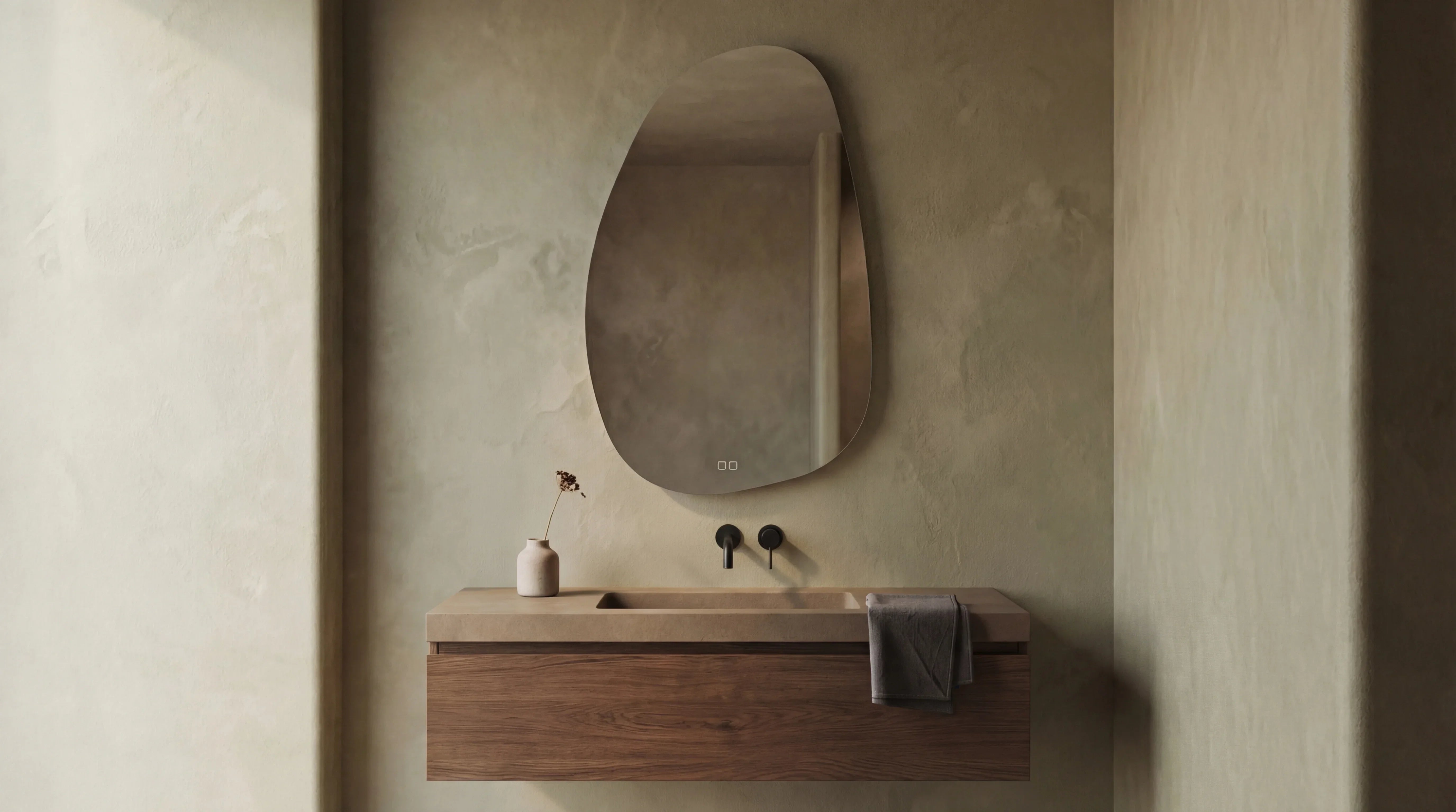 STONE Terra mirror in a sculptural backlit bathroom installation. Organic asymmetric form.