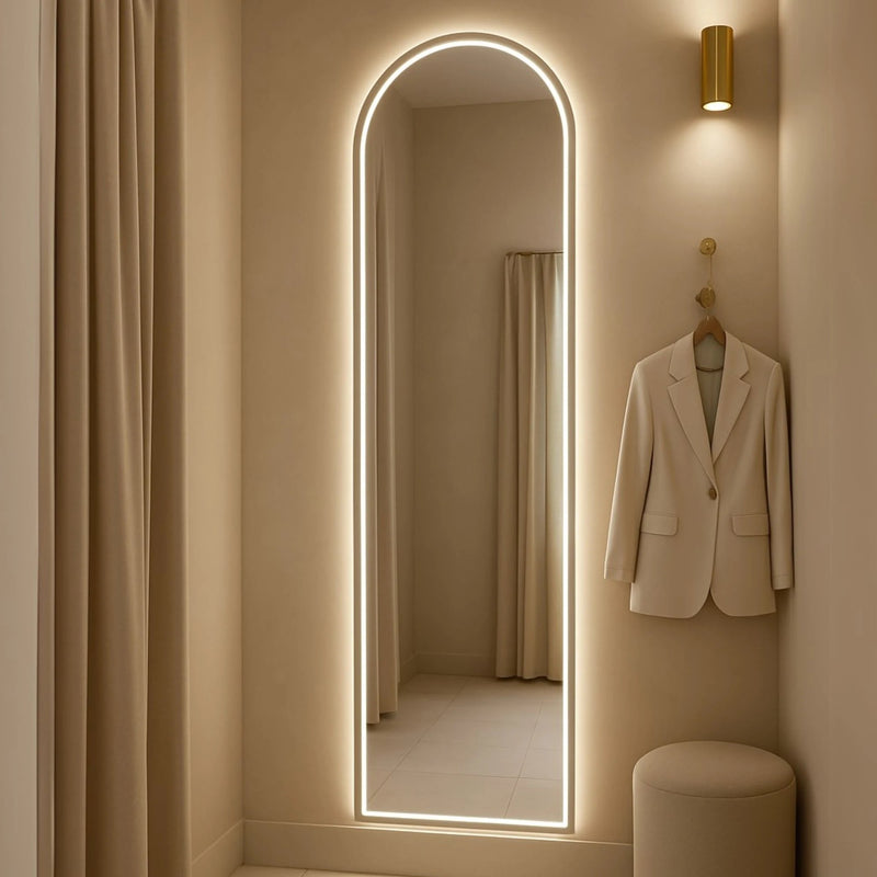 Marlowe arched backlit LED mirror for a dressing room, home-living setting. Claris Company.