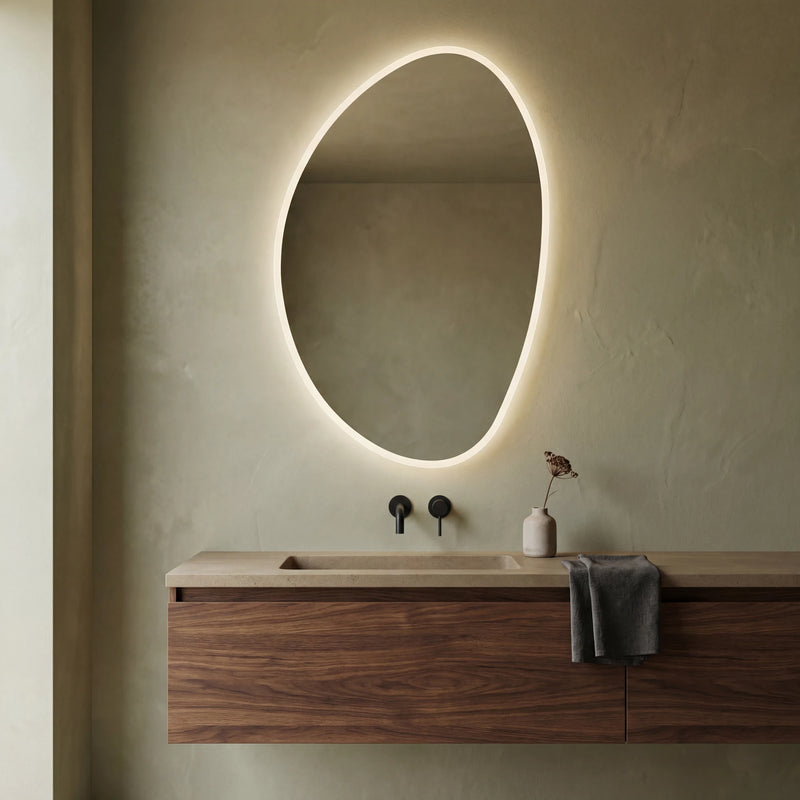 Claris PEBBLE asymmetric backlit LED bathroom mirror with river-stone silhouette, Terra Collection