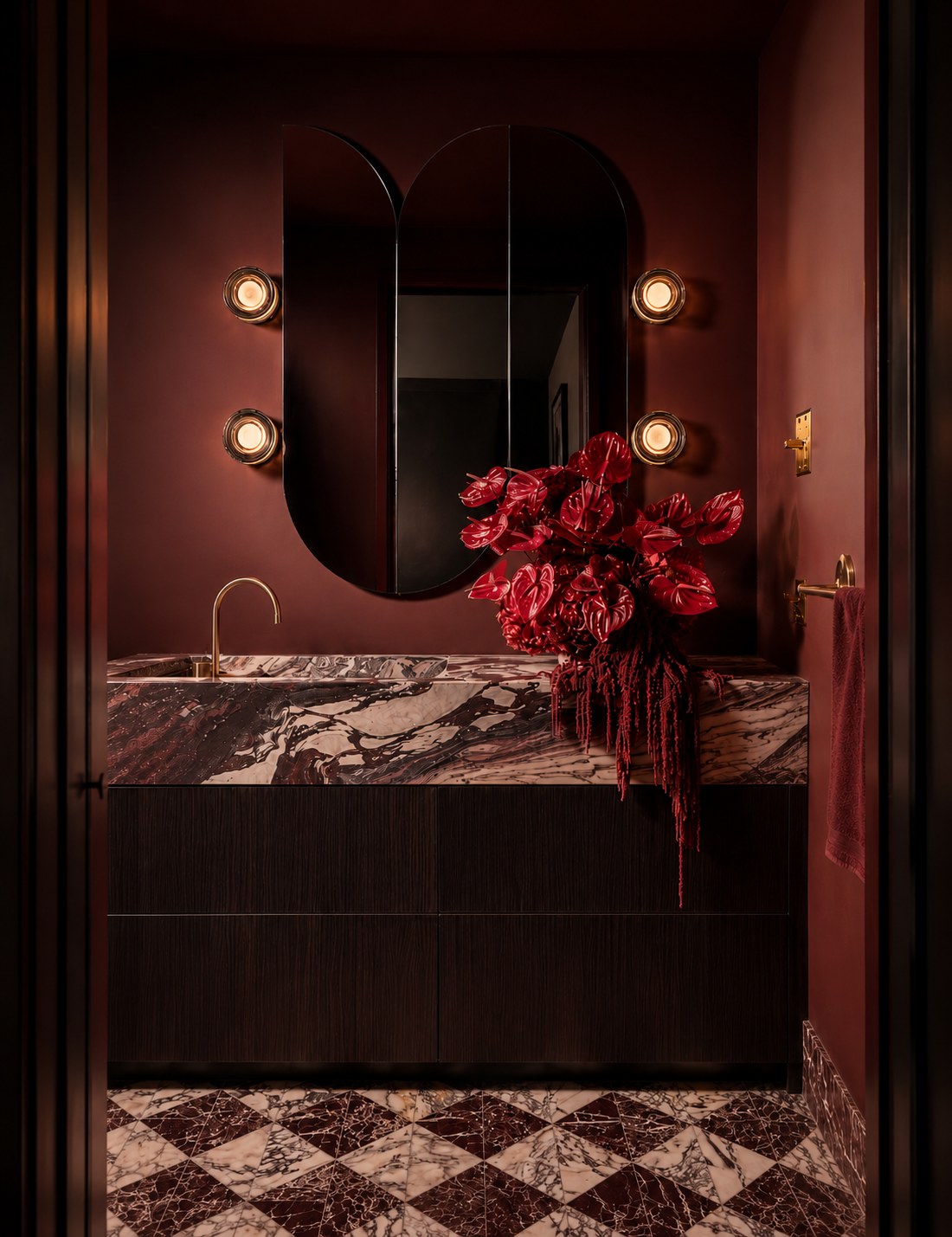 A custom twin-arch tinted Claris mirror in a deep oxblood powder room by Phoenix Grey
