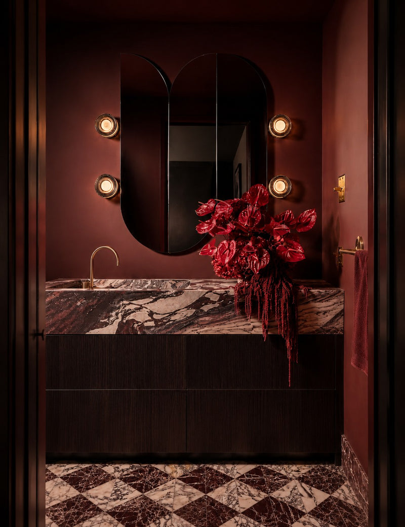 A custom twin-arch tinted Claris mirror in a deep oxblood powder room by Phoenix Grey