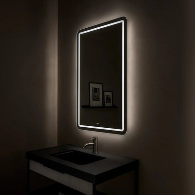 Bathroom vanity with illuminated mirror in a dimly lit room
