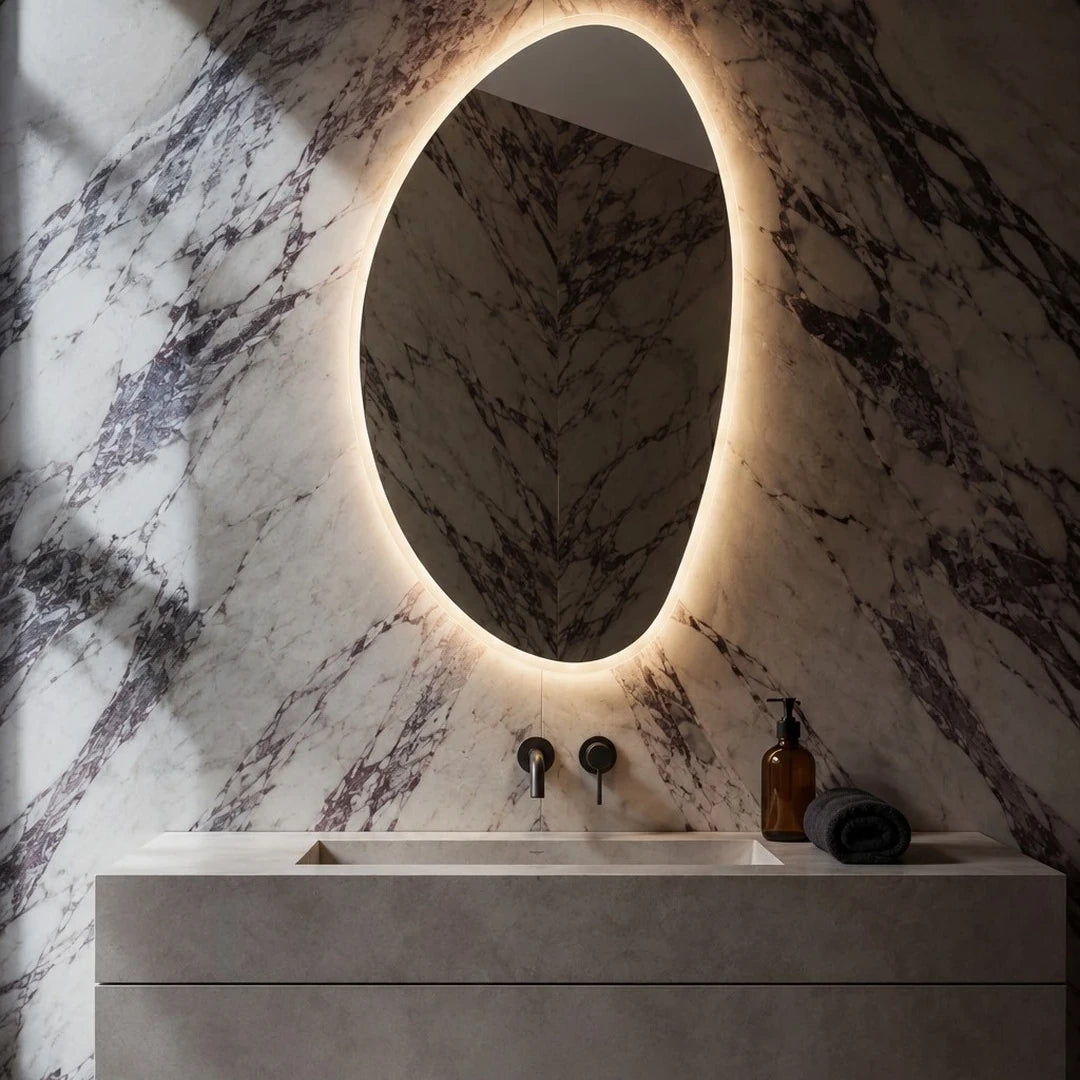 Claris PEBBLE mirror on a Calacatta Viola marble wall over a concrete vanity