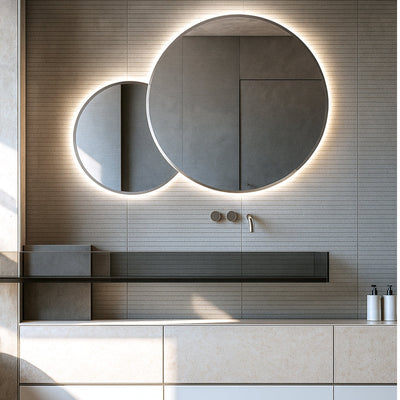Modern bathroom with round illuminated mirror and sleek vanity.