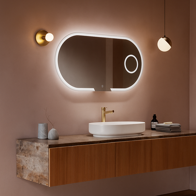 Bathroom vanity with illuminated mirror and lighting fixtures on a pink wall.