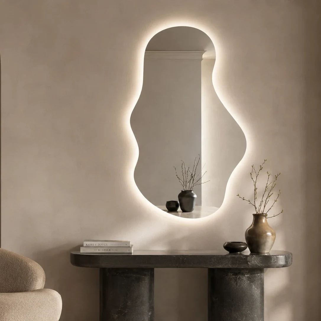 Claris EMIRA free-flowing organic backlit LED mirror in a home-living interior, Terra Collection