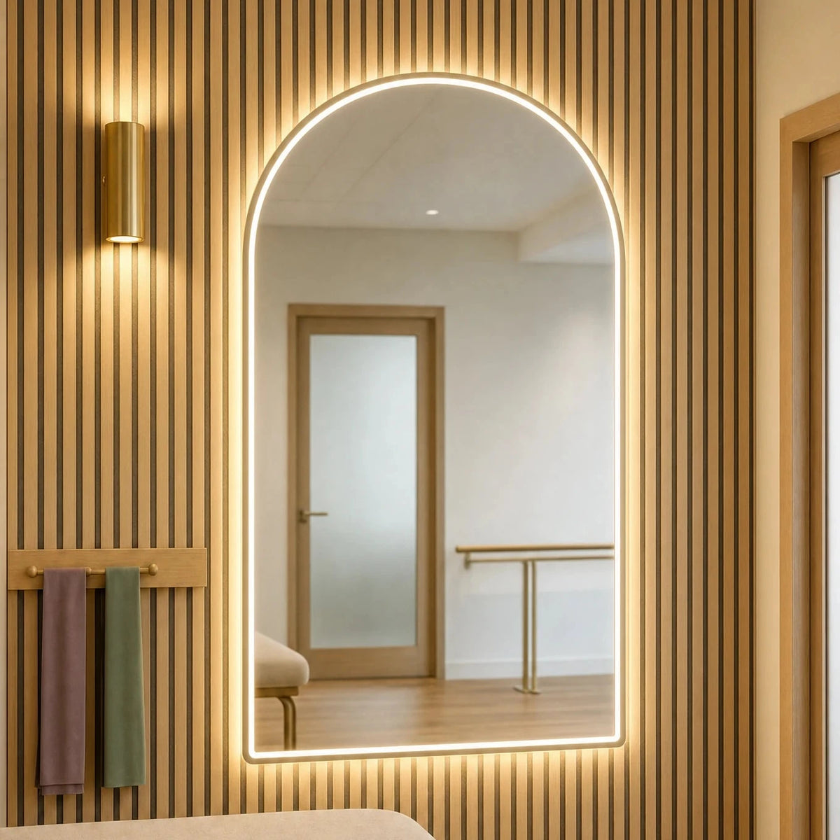 Claris MARLOWE STUDIO front-lit arched mirror in a physiotherapy treatment room, Studio Line