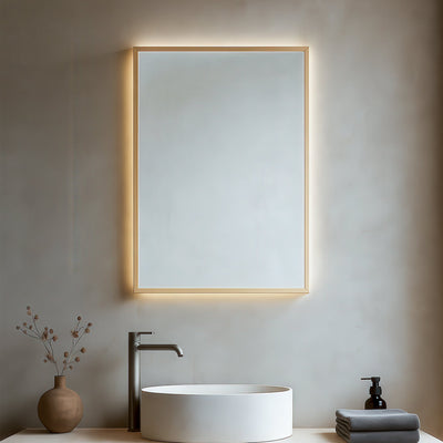Bathroom vanity with illuminated mirror, sink, and decorative elements.