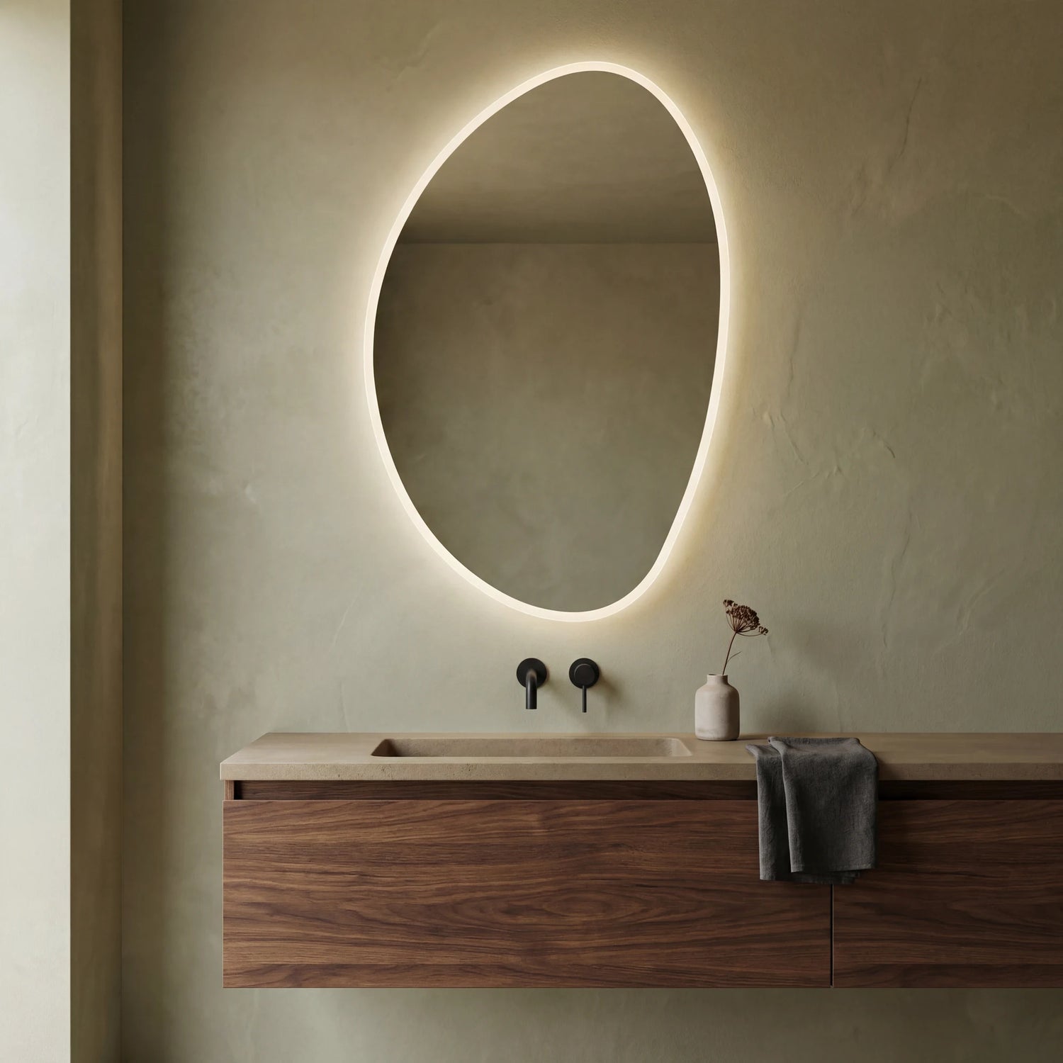 Claris PEBBLE asymmetric backlit LED bathroom mirror with river-stone silhouette, Terra Collection