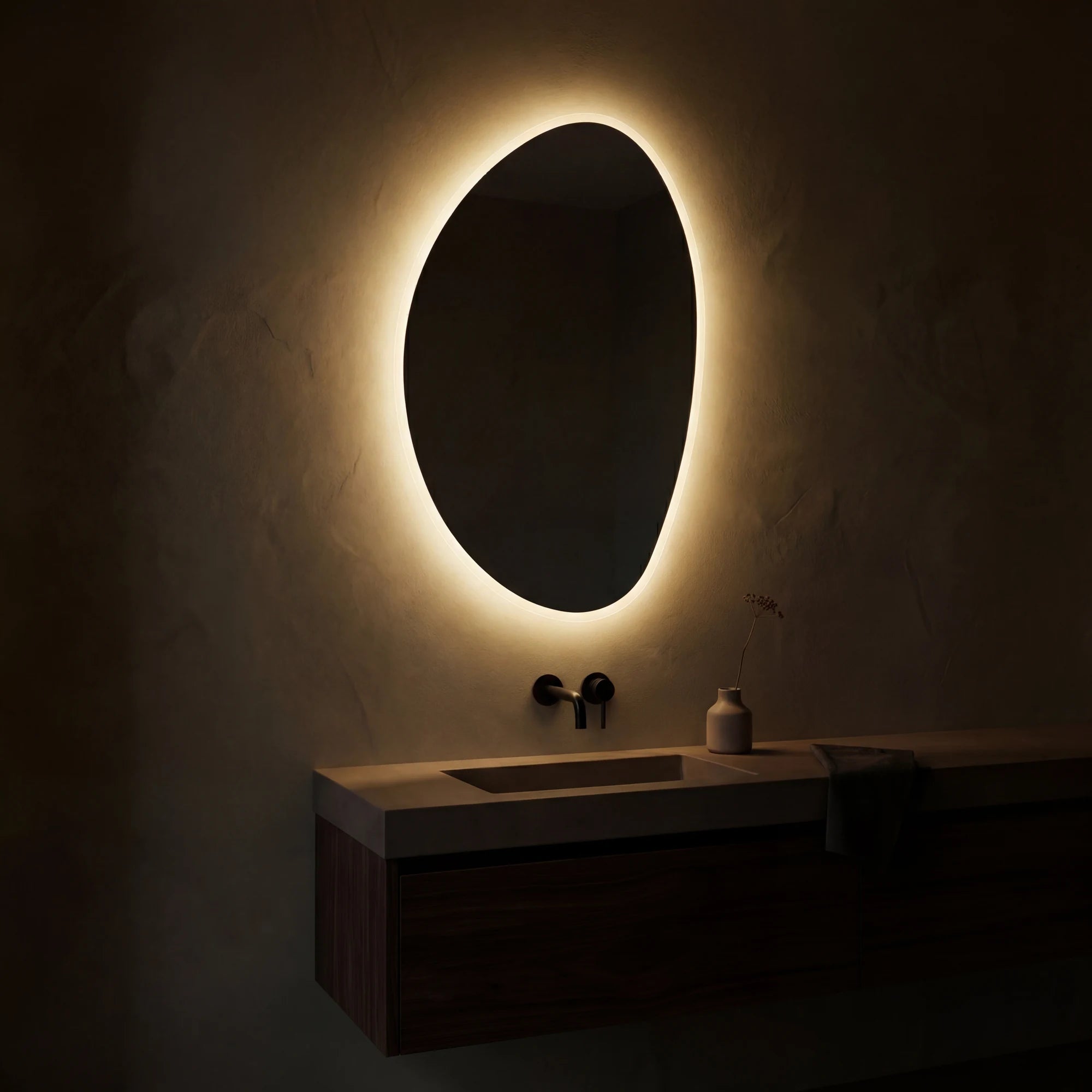Claris PEBBLE asymmetric backlit LED bathroom mirror with river-stone silhouette, Terra Collection