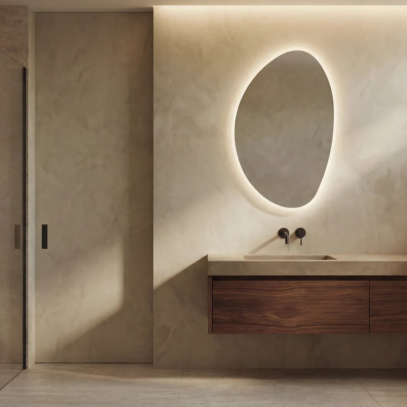 Claris PEBBLE asymmetric backlit LED bathroom mirror with river-stone silhouette, Terra Collection